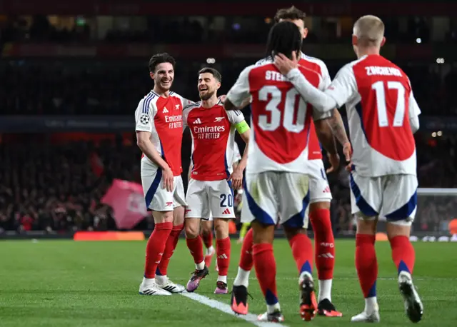 Declan Rice celebrates with teammates against PSV in the last 16