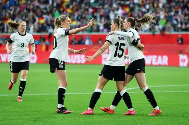 Cerci celebrates with her team-mates