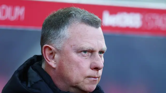 Stoke boss Mark Robins looks on from the touchline