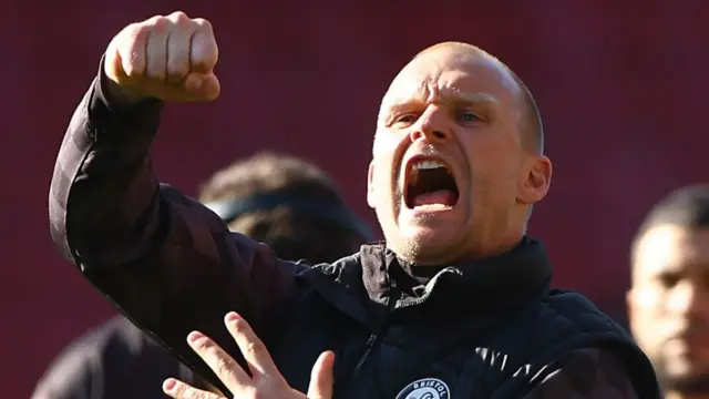 Liam Manning celebrates