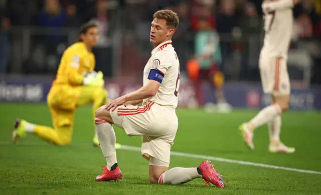 Kimmich kneels on the floor