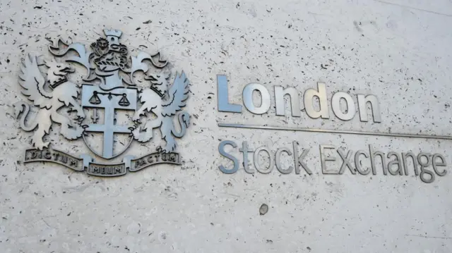 A close up of the metal sign on the wall that signposts the London Stock Exchange