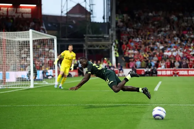 Michael Kayode falls over as runs to stop the ball