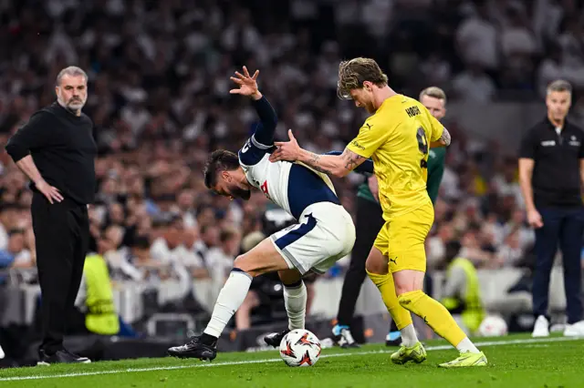 Rodrigo Bentacur of Tottenham Hotspur (L) is challenged by Kasper Hogh