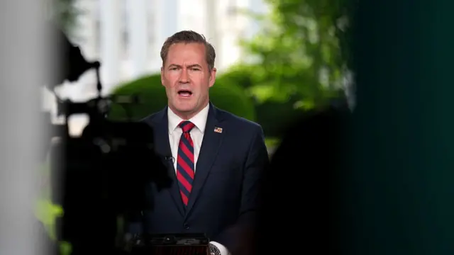 Mike Waltz speaks on TV being filmed by a camera