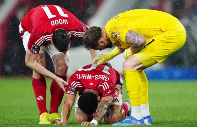 Nottingham Forest's Morgan Gibbs-White (centre) is consoled by Chris Wood and Brentford goalkeeper Mark Flekken