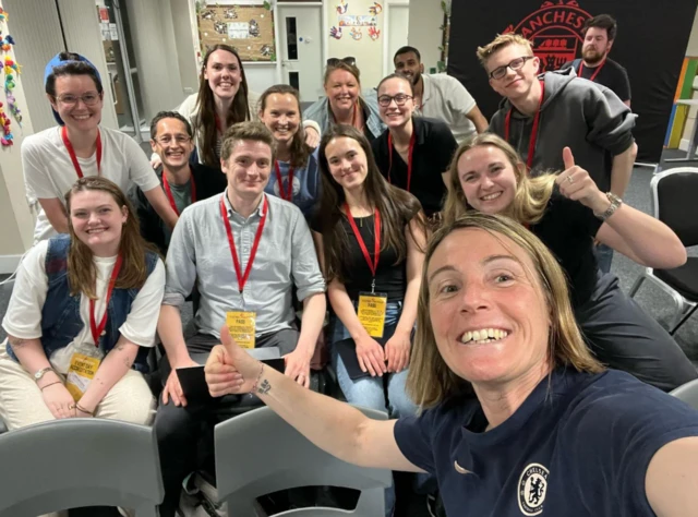 Sonia Bompastor takes a selfie with media