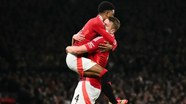 Manchester United's Dutch defender Matthijs de Ligt celebrates with Manchester United's Ivorian midfielder Amad Diallo after scoring a goal that will be ruled out during the UEFA Europa league football match between Manchester United and Glasgow Rangers at Old Trafford stadium in Manchester.