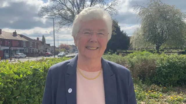 Labour’s Ros Jones smiles to camera. She is standing outside, with a street behind her