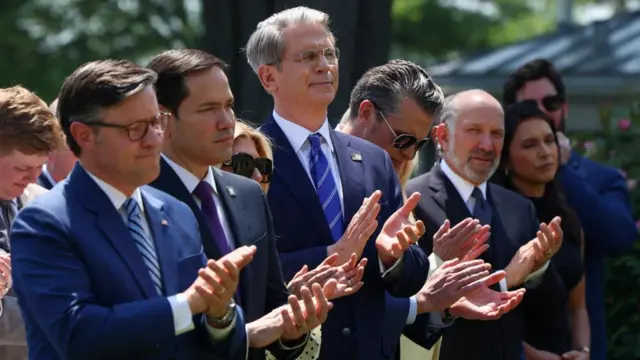 Speaker Mike Johnson, Marco Rubio, Scott Bessent, Pete Hegseth, Howard Lutnik and Tulsi Gabbard stand and clap as President Trump arrives.