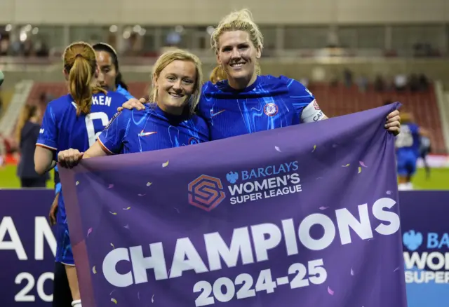 Chelsea's Millie Bright (right) and Chelsea's Erin Cuthbert hold up a champions flag