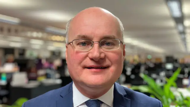 Conservative politician Simon Geraghty, a man balding on top but with short grey hair on the sides of his head and glasses.