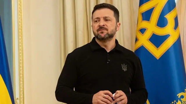 Volodymyr Zelensky wears a black top.