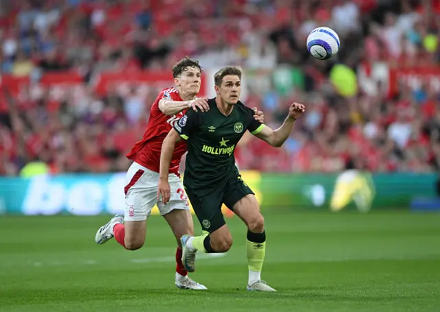 Yehor Yarmolyuk of Brentford is challenged by Ryan Yates