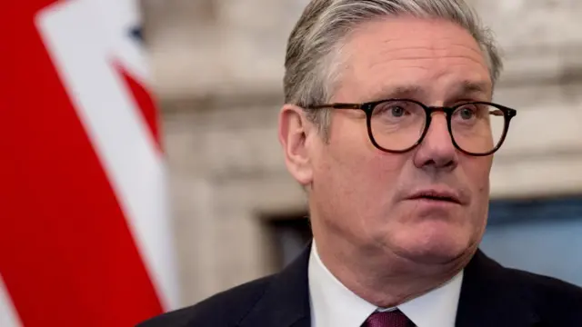 Keir Starmer pictured in close-up with the British flag in the background