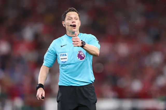 Referee Darren England looks on