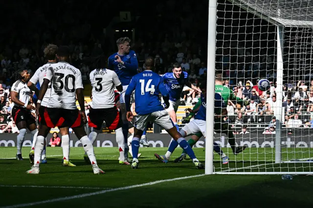 Michael Keane (rear R) scores