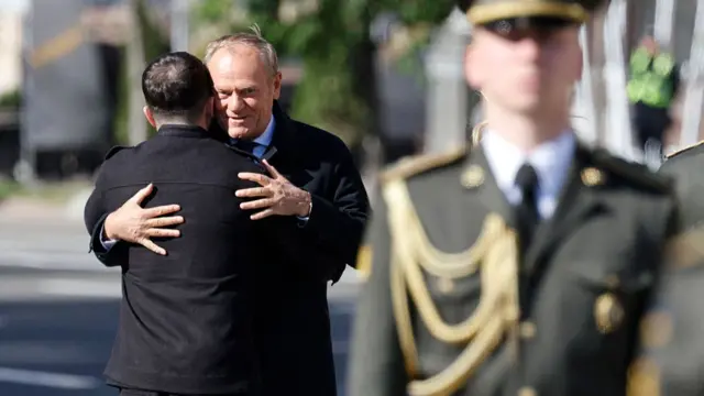 Ukraine's President Volodymyr Zelensky greets Poland's Prime Minister Donald Tusk at the Independence Square