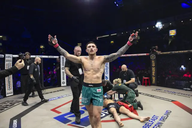 Connor Hughes celebrates a win with his opponent down behind him