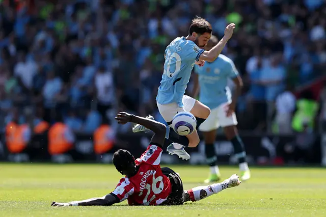 Bernardo Silva of Manchester City is challenged by Lesley Ugochukwu