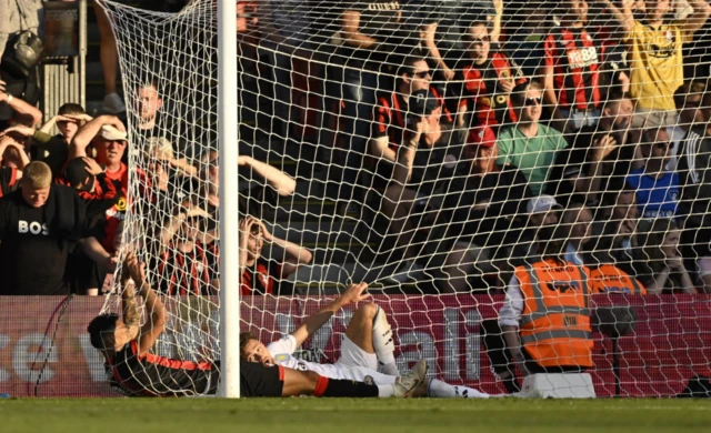 AFC Bournemouth's Daniel Jebbison and Aston Villa's Matty Cash fall into the goal