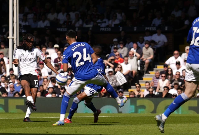 Fulham’s Alex Iwobi (left) hits a shot towards goal