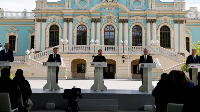 German chancellor Friedrich Merz, French president Emmanuel Macron, Ukrainian president Voloydmyr Zelensky, UK prime minister Sir Keir Starmer and Polish prime minister Donald Tusk stand side-by-side at lecterns as they give a press conference