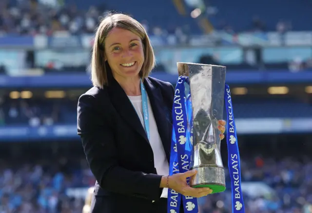 Chelsea manager Sonia Bompastor celebrates with the trophy after winning the Women's Super League