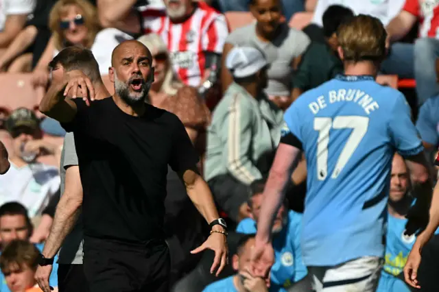 Pep Guardiola gestures on the touchline