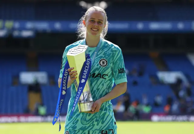 Chelsea's Hannah Hampton celebrates with the trophy