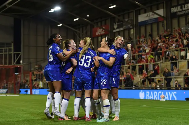 Lucy Bronze of Chelsea celebrates with teammates after scoring her team's first goal during a Barclays Women's Super League match between Manchester United and Chelsea FC at Leigh Sports Village on April 30, 2025 in Leigh, England. (