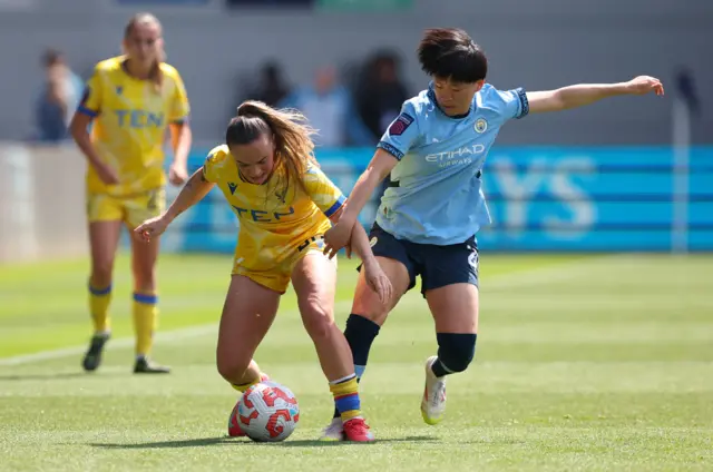 Crystal Palace's Lily Woodham in action with Manchester City's Aoba Fujino