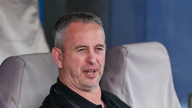 Steve McNamara sitting on the bench at Huddersfield