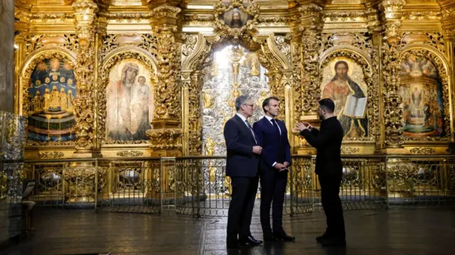Keir Starmer and Emmanuel Macron listen to Volodymyr Zelensky speak inside Saint Sophia Cathedral, which is heavily decorate in gold