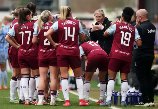 Rehanne Skinner talks to her players on the touchline