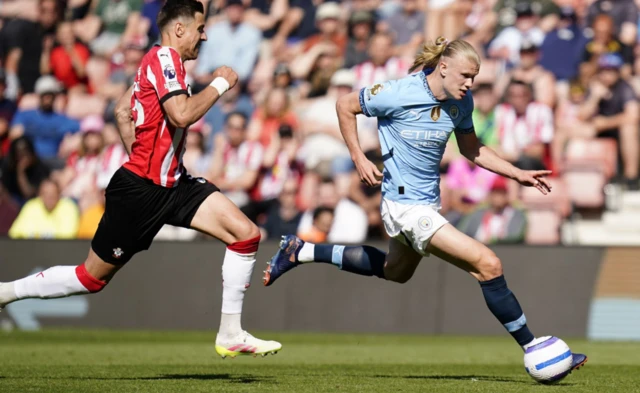 Manchester City's Erling Haaland (right) gets away