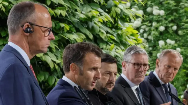 Merz, Macron, Zelensky, Starmer, Tusk speak behind podiums in Kyiv.