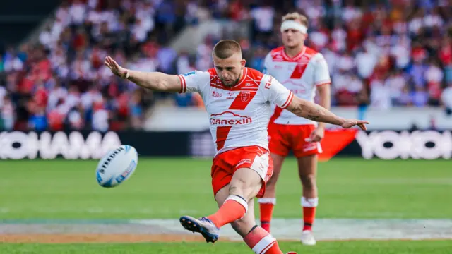 Mikey Lewis kicks to goal