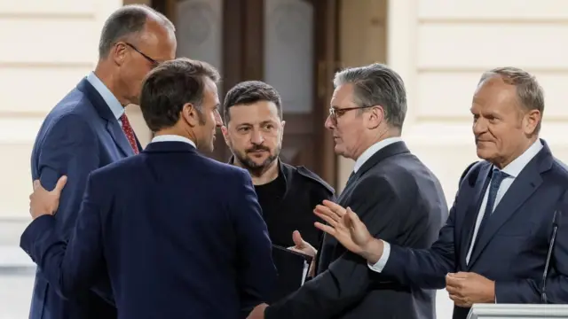 Zelensky stands in between Merz, Macron, Starmer and Tusk.