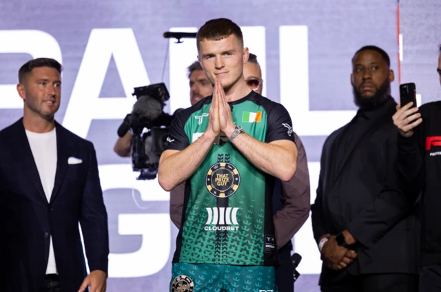 Paul Hughes makes a peace sign with his hands