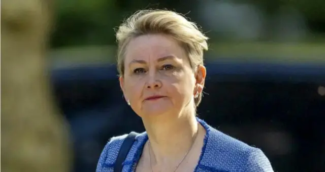 Yvette Cooper wearing a blue jacket looks to camera