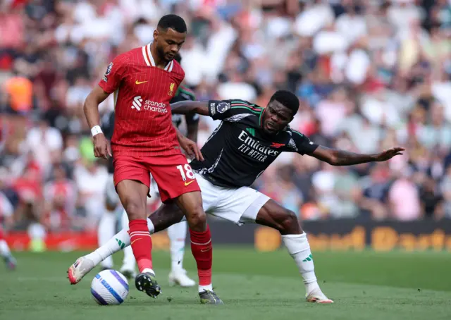 Liverpool's Cody Gakpo in action with Arsenal's Thomas Partey