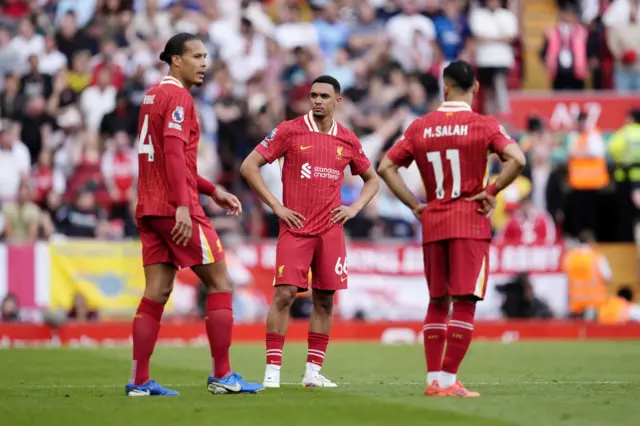 Liverpool's Trent Alexander-Arnold (centre), Virgil van Dijk (left) and Mohamed Salah stand dejected
