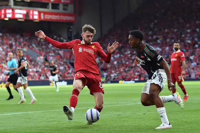 Liverpool's Northern Irish defender #84 Conor Bradley (L) vies with Arsenal's English midfielder #49 Myles Lewis-Skelly (R) during the English Premier League football match between Liverpool and Arsenal at Anfield in Liverpool, north west England on May 11, 2025.