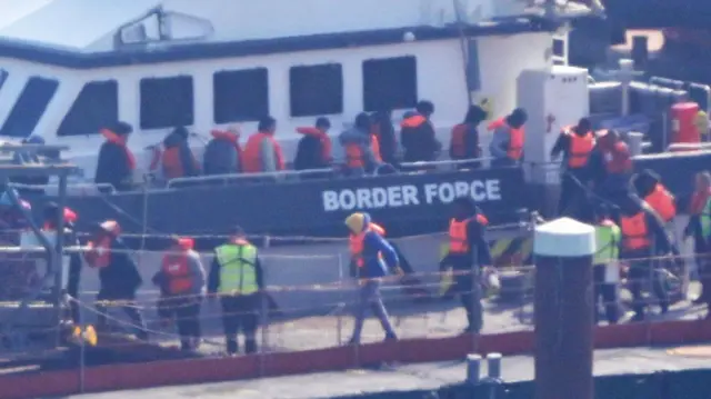 A group of people thought to be migrants are brought in to Dover