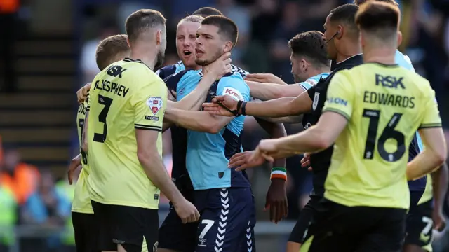 Wycombe and Charlton players clash