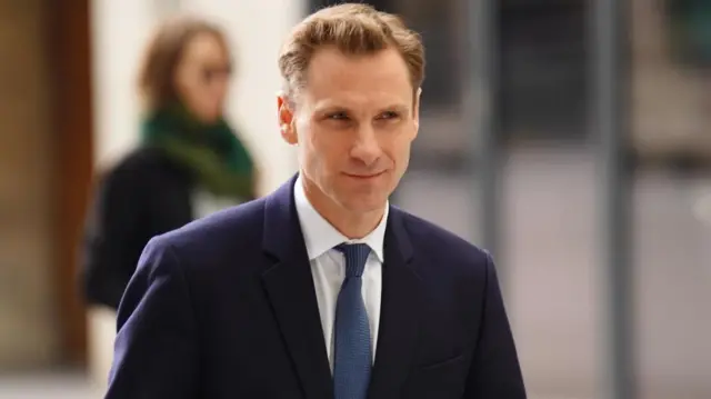 Chris Philp in a suit.
