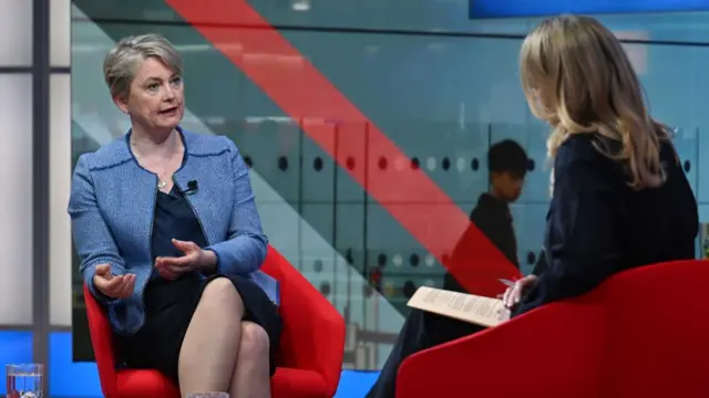 Yvette Cooper wears a blue blazer and speaks on the BBC's Laura Kuenssberg programme in a studio.