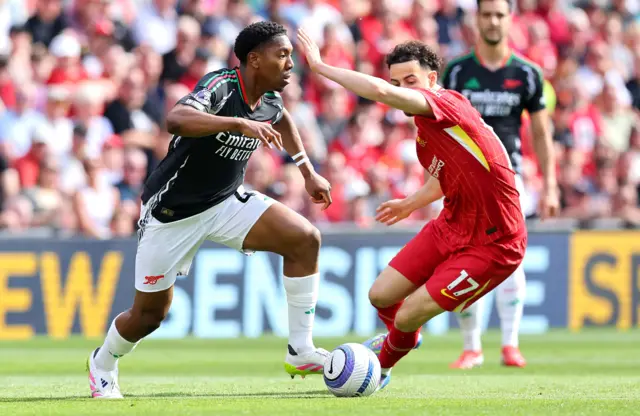 Curtis Jones (R) of Liverpool in action against Myles Lewis-Skelly.