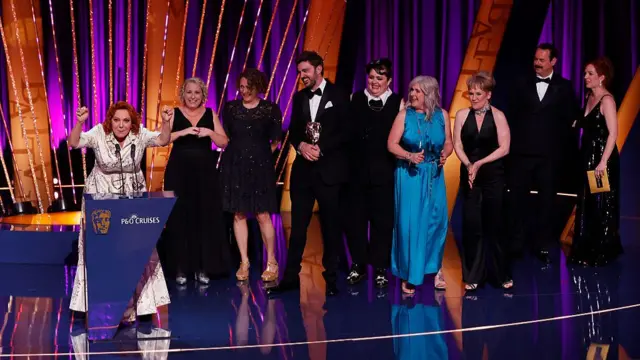 Cast of Alma's not normal on Bafta stage as they collect their award, Sophie Willan in a white dress speaks